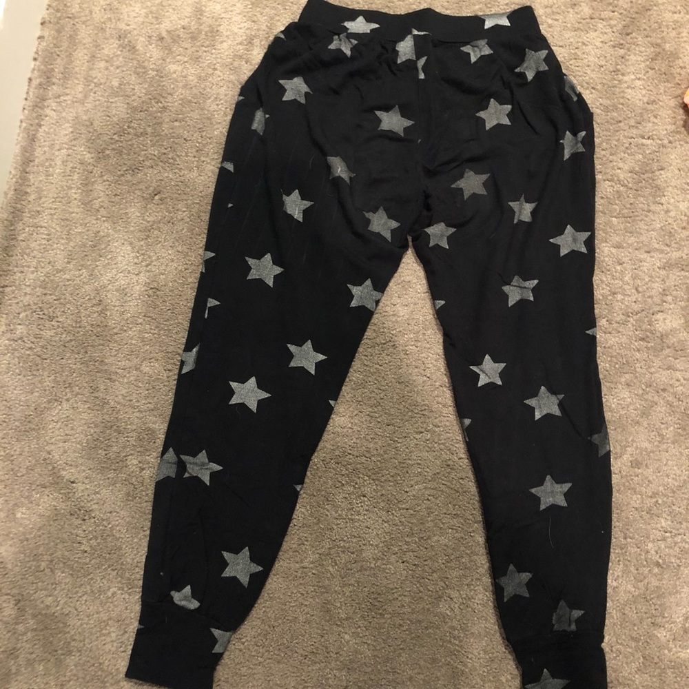 Black knit joggers with silver stars.  Super soft material.  Side pockets.